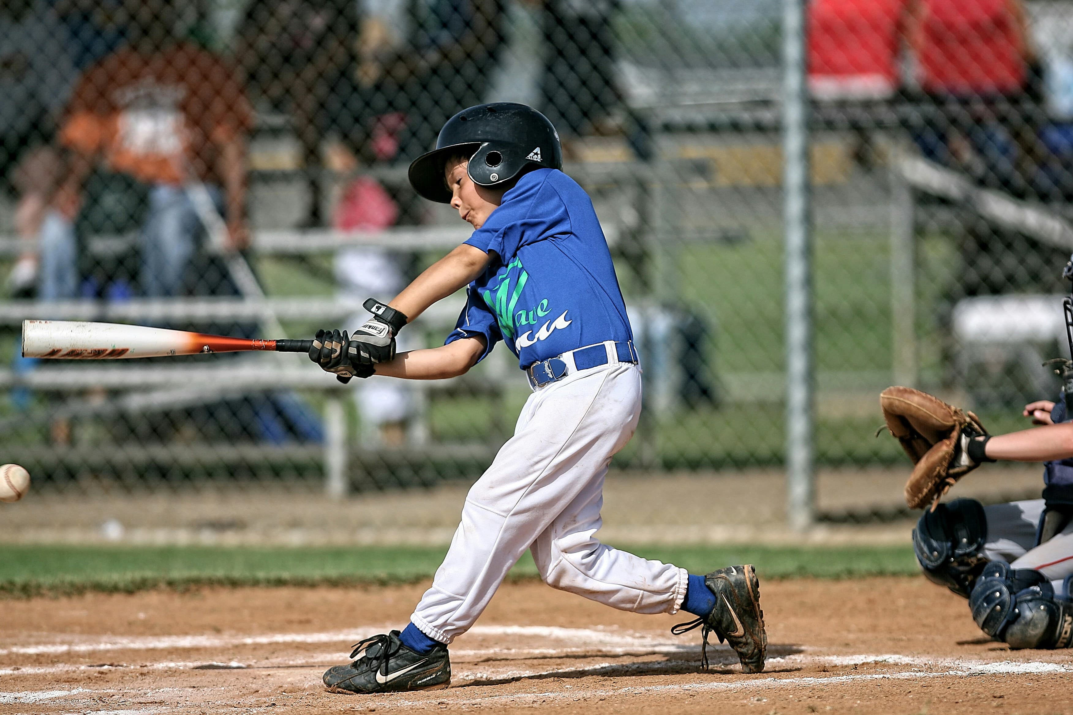 Baseball player Jake mid-swing at the plate